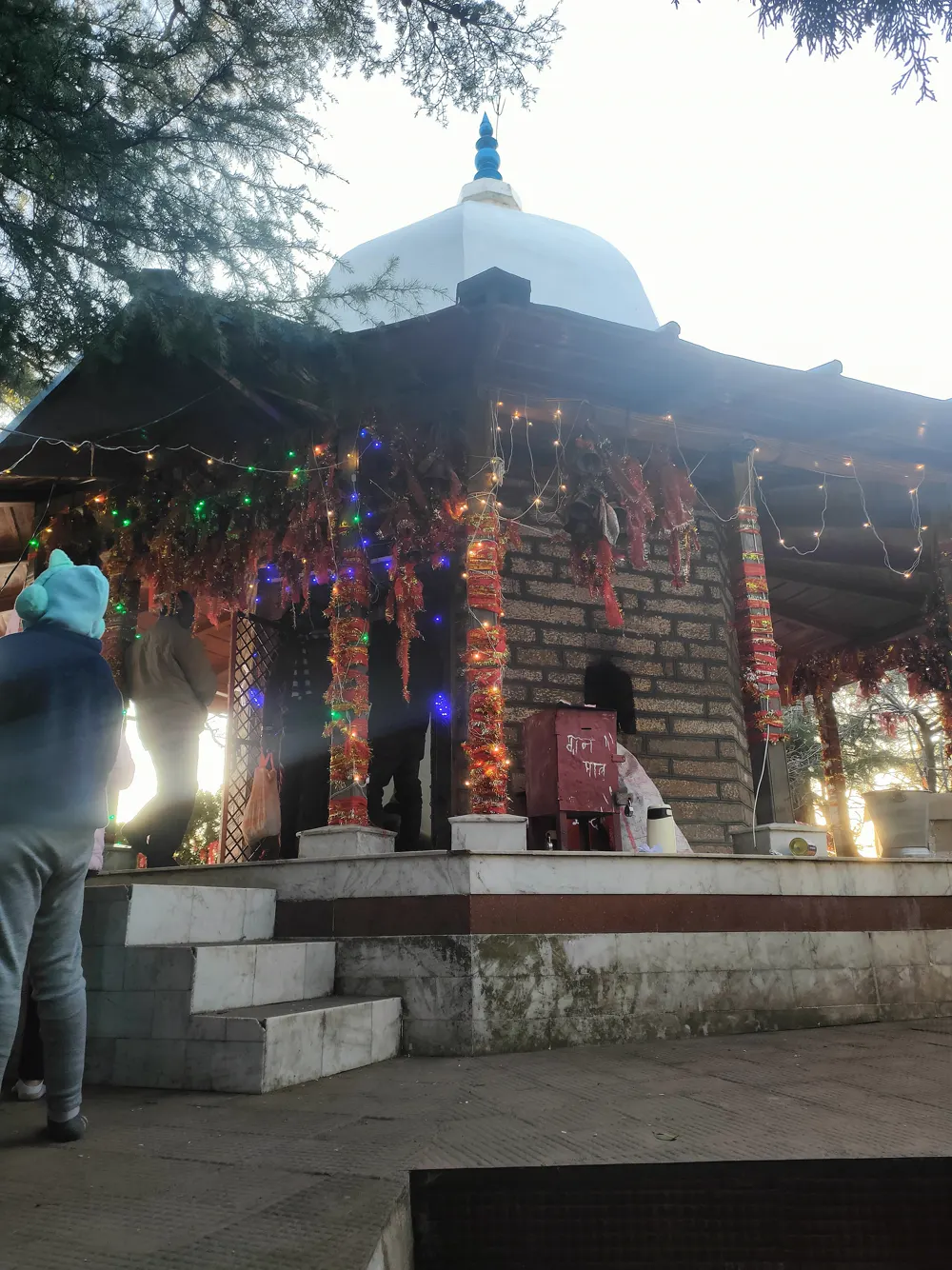 Mukteshwar Dham temple lit up at dusk